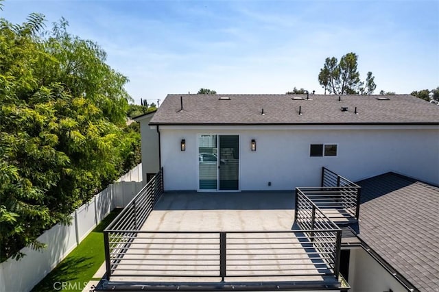 back of property featuring a patio area, a fenced backyard, a shingled roof, and stucco siding