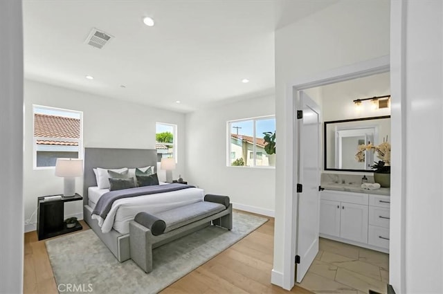 bedroom featuring recessed lighting, visible vents, baseboards, and ensuite bathroom