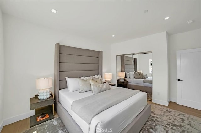 bedroom featuring recessed lighting, baseboards, and wood finished floors