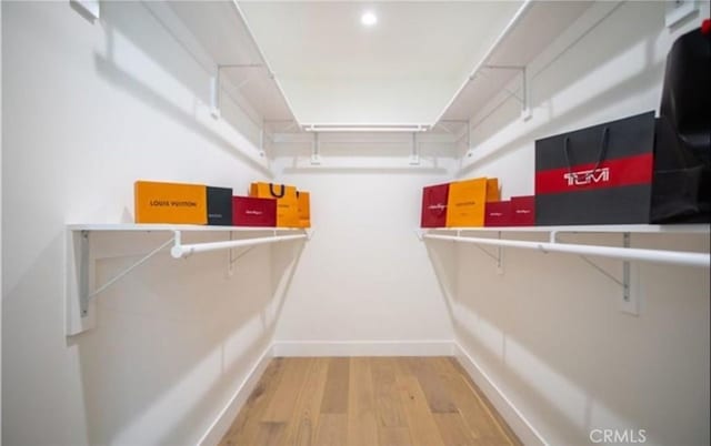 spacious closet with wood finished floors