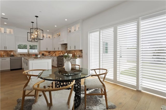 dining space with recessed lighting, a notable chandelier, light wood-type flooring, and visible vents