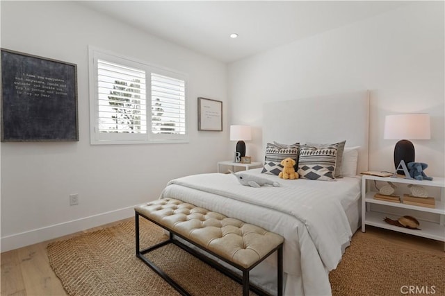 bedroom featuring baseboards, recessed lighting, and wood finished floors