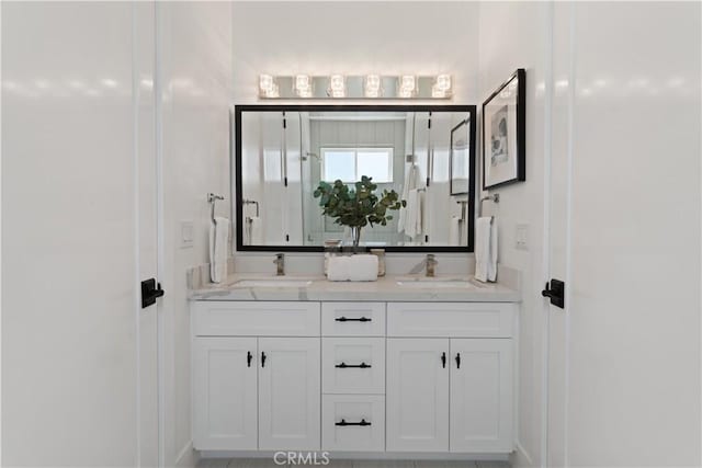 full bath with double vanity and a sink