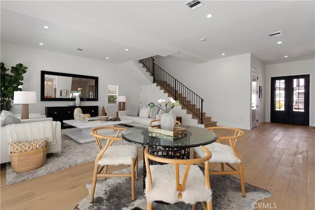 dining area featuring visible vents, light wood-style flooring, stairway, and recessed lighting