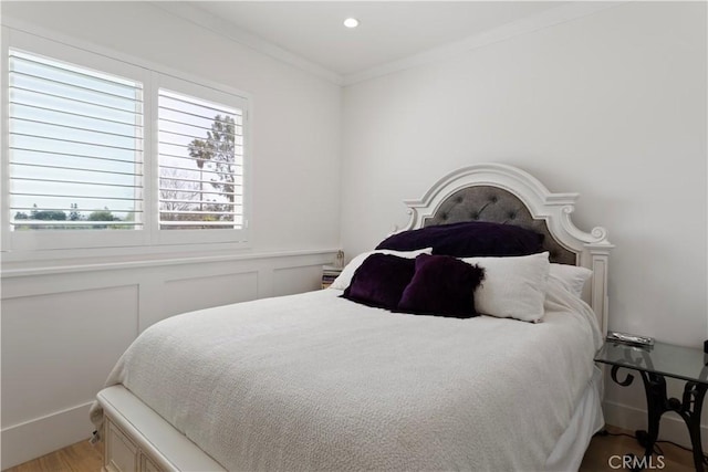 bedroom with recessed lighting, crown molding, and wood finished floors