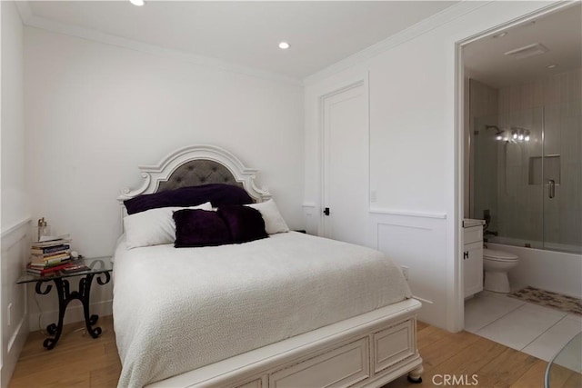 bedroom with recessed lighting, ensuite bath, light wood-style flooring, and ornamental molding