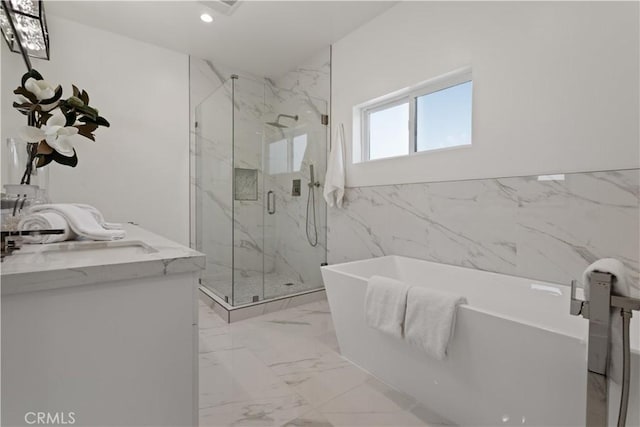bathroom featuring tile walls, a soaking tub, recessed lighting, a marble finish shower, and marble finish floor