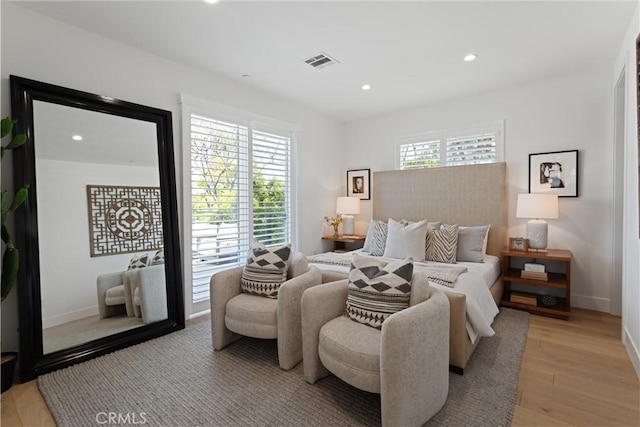 bedroom with visible vents, baseboards, light wood finished floors, and recessed lighting