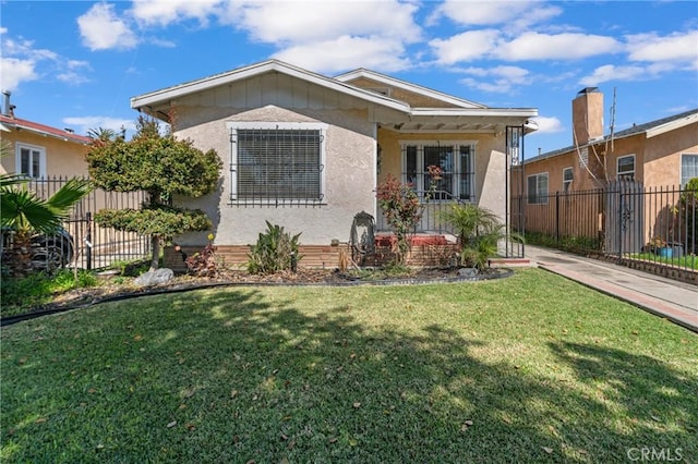 bungalow-style house with stucco siding, a front yard, and fence