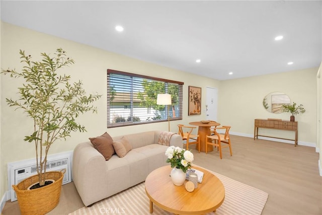 living area with recessed lighting, visible vents, baseboards, and light wood-style flooring