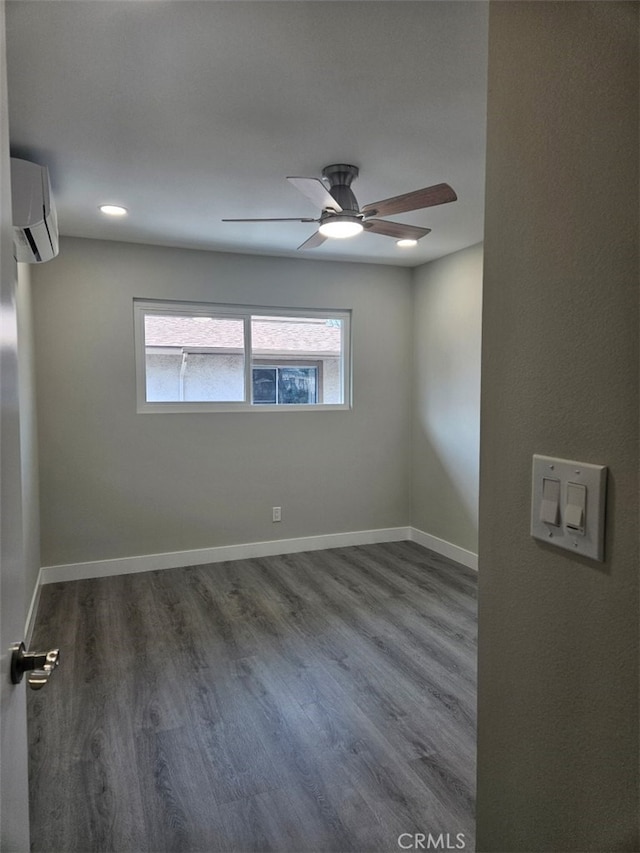 empty room featuring baseboards, ceiling fan, wood finished floors, a wall mounted AC, and recessed lighting