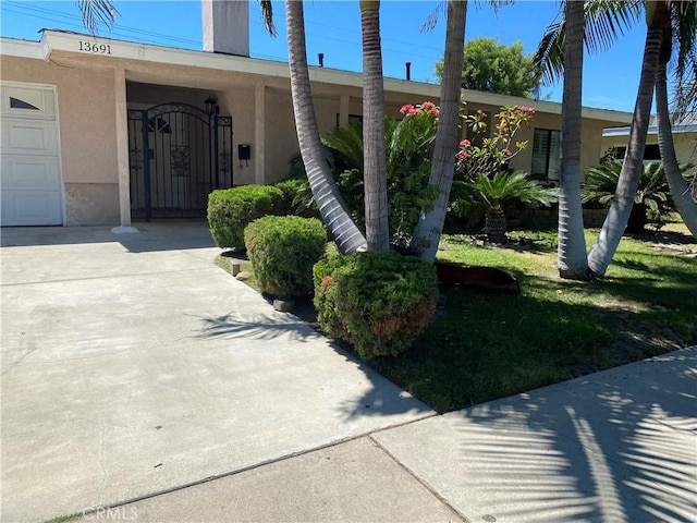 property entrance with a gate and stucco siding