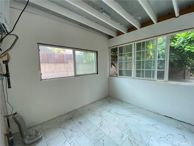 spare room with marble finish floor