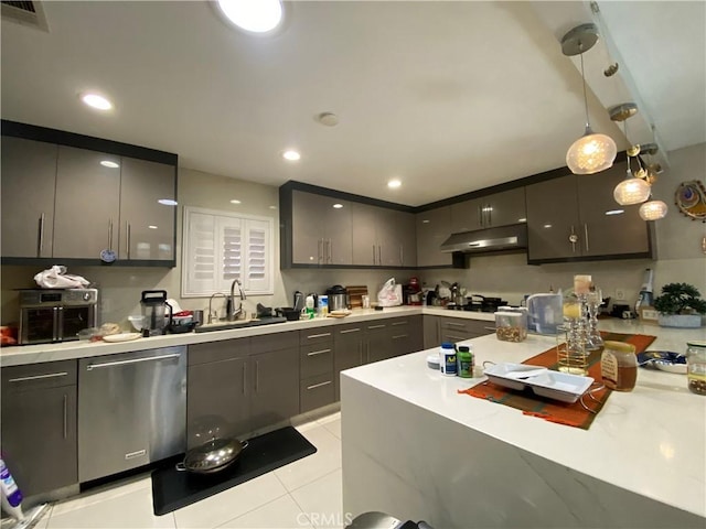 kitchen with light countertops, visible vents, stainless steel dishwasher, a sink, and under cabinet range hood