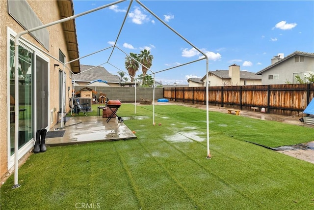 view of yard with a patio and a fenced backyard