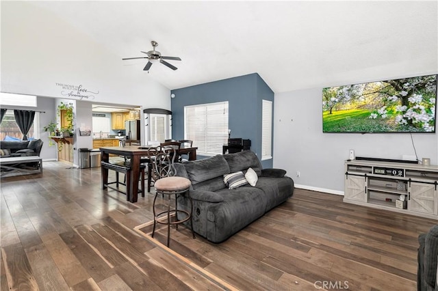 living room featuring baseboards, wood-type flooring, ceiling fan, and vaulted ceiling