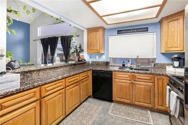 kitchen featuring a sink, dark stone countertops, stainless steel range with gas cooktop, lofted ceiling, and dishwasher