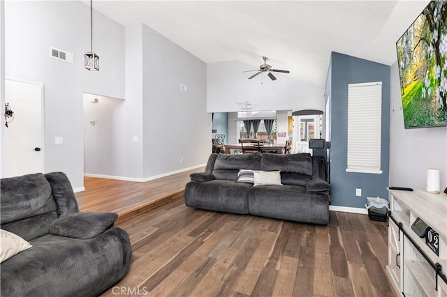 living area with baseboards, visible vents, high vaulted ceiling, dark wood-style flooring, and ceiling fan