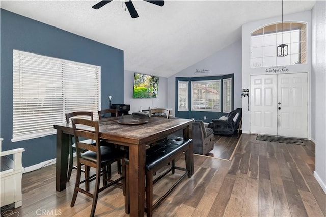 dining area featuring vaulted ceiling, baseboards, wood-type flooring, and ceiling fan