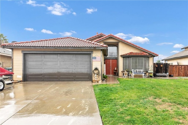 view of front facade with a tile roof, fence, concrete driveway, an attached garage, and a front yard