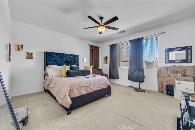 carpeted bedroom with visible vents and a ceiling fan