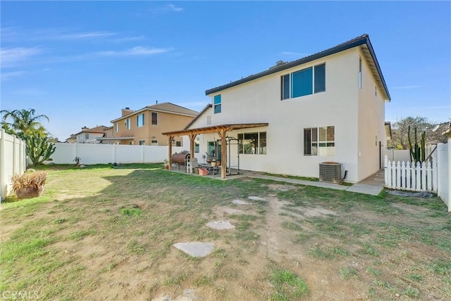 rear view of property featuring cooling unit, a fenced backyard, a lawn, and a patio