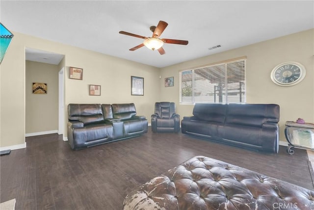 living area with a ceiling fan, visible vents, baseboards, and wood finished floors