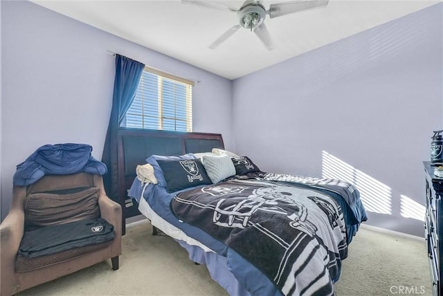 carpeted bedroom featuring a ceiling fan and baseboards