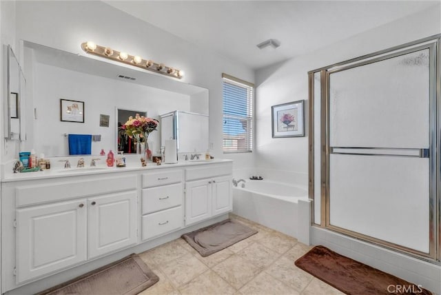 full bathroom featuring double vanity, a sink, a shower stall, and a bath