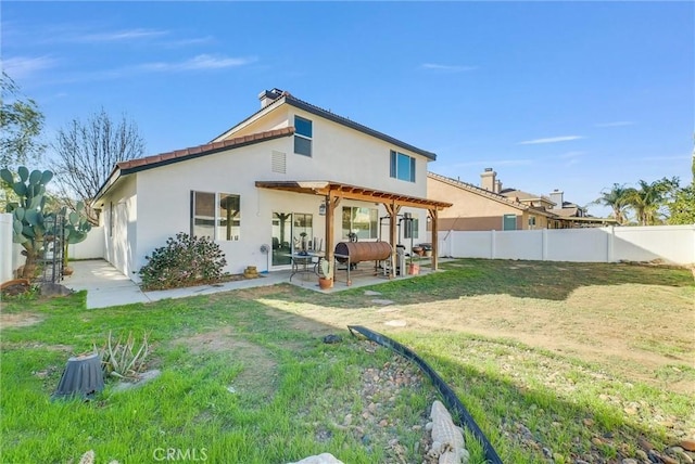 back of house featuring a patio, a fenced backyard, a lawn, a pergola, and stucco siding