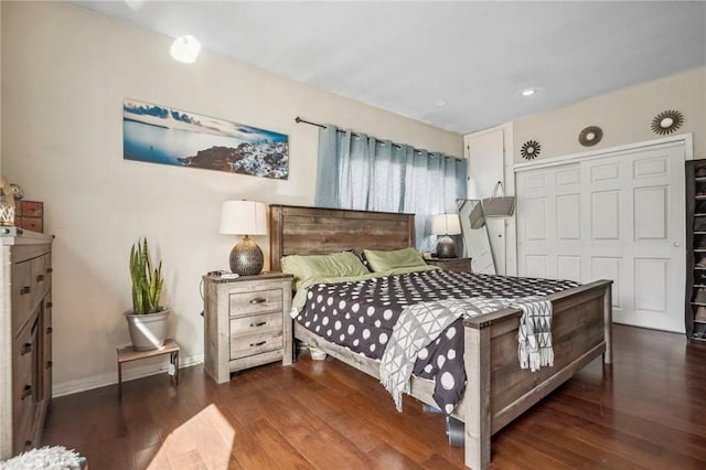 bedroom featuring wood finished floors, a closet, and baseboards