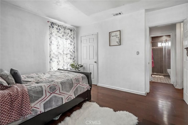 bedroom featuring visible vents, baseboards, and hardwood / wood-style floors