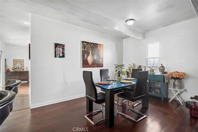 dining area with baseboards and hardwood / wood-style floors