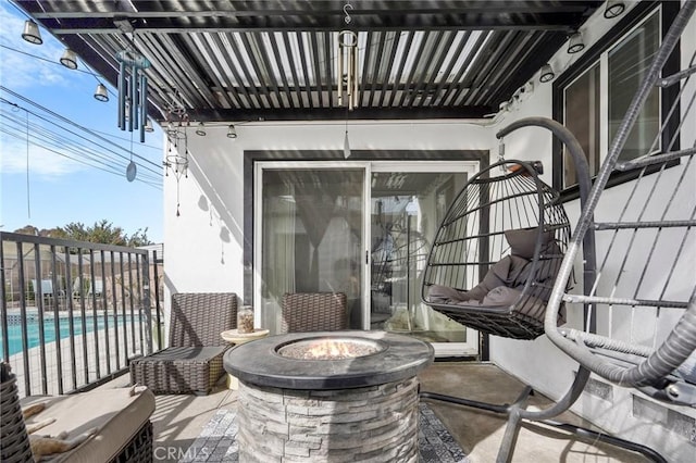 view of patio / terrace with a community pool and an outdoor fire pit