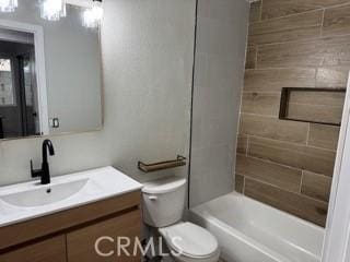 full bathroom with bathtub / shower combination, vanity, and toilet