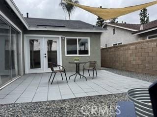 view of patio with french doors and fence