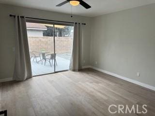 empty room with ceiling fan, baseboards, and wood finished floors