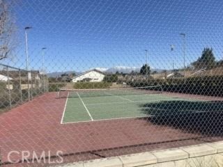 view of sport court featuring fence