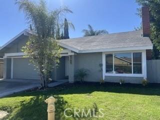 ranch-style home with a garage and a front yard