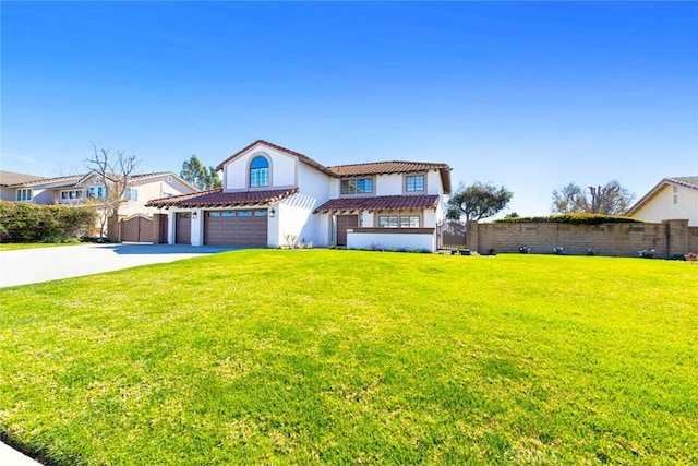 view of front of house with a front yard, fence, concrete driveway, and a tiled roof