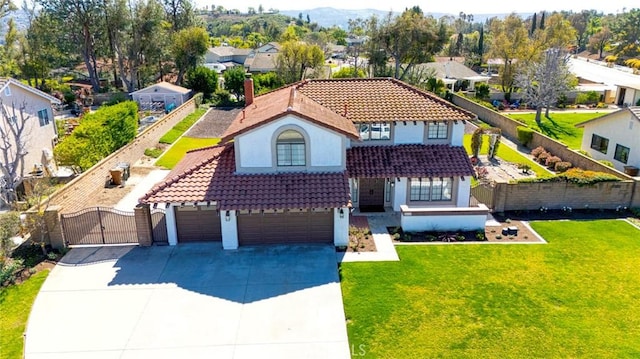 view of front of house with a tiled roof, fence, a gate, and stucco siding