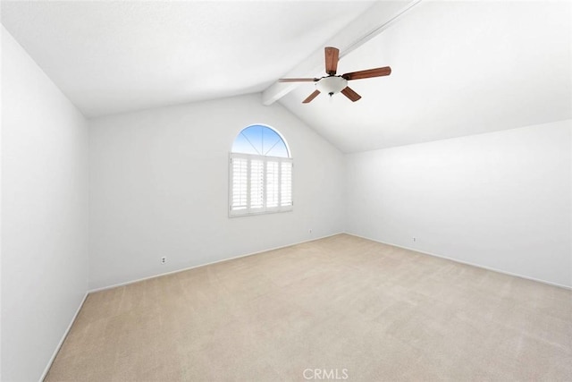 empty room featuring vaulted ceiling with beams, ceiling fan, and light colored carpet