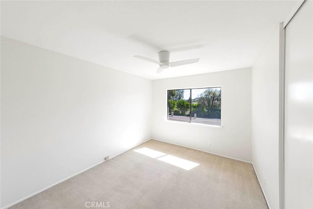 empty room with light carpet and ceiling fan