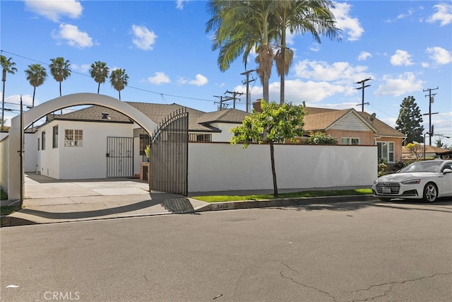 view of front of home featuring a fenced front yard and a gate