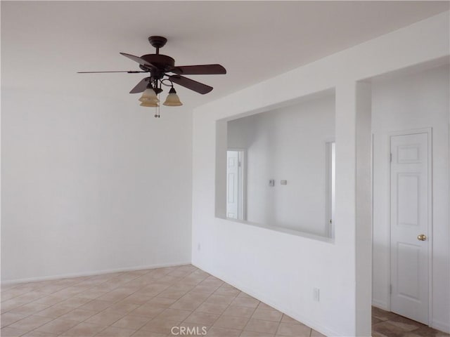 empty room featuring baseboards and ceiling fan