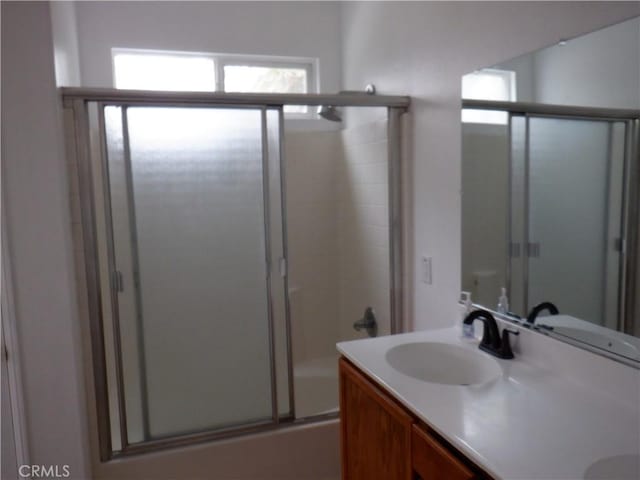 full bathroom with bath / shower combo with glass door and vanity