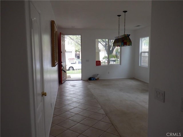 unfurnished dining area with light tile patterned floors