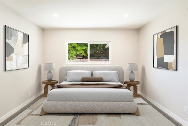 bedroom with recessed lighting, baseboards, and wood finished floors