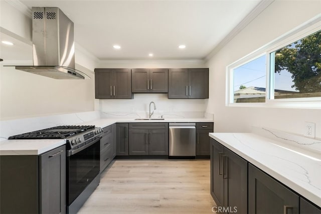 kitchen featuring a sink, appliances with stainless steel finishes, ornamental molding, light stone countertops, and island exhaust hood