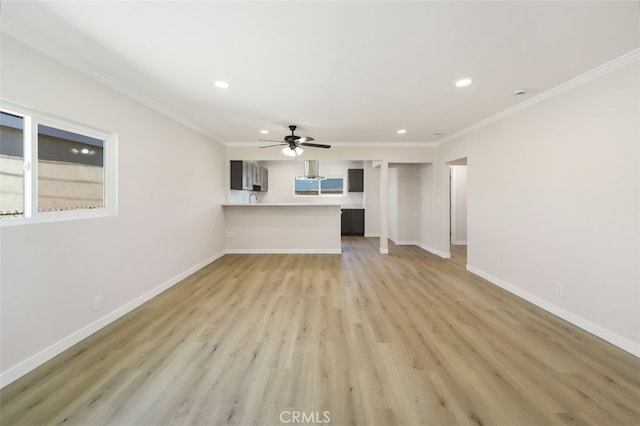 unfurnished living room with ornamental molding, recessed lighting, light wood-style flooring, and baseboards